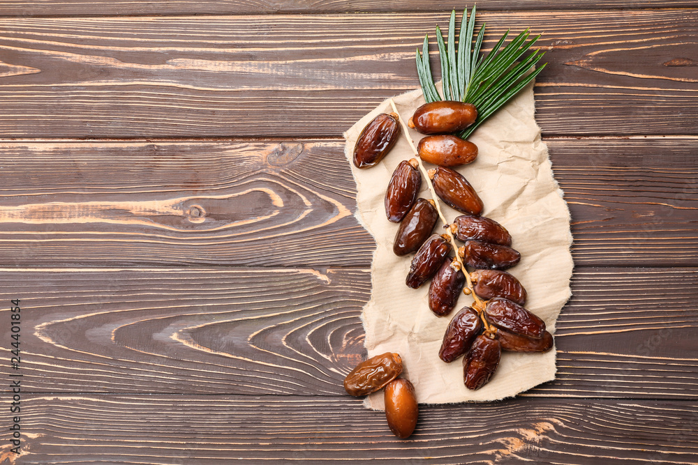 Sweet dried dates on wooden background