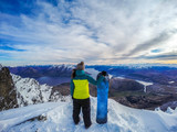 Fototapeta Most - Winter sport activity.Woman holding snowboard, overlooking mountain landscape freedom, enjoying a winter, cold season. Having fun on the snow, mountains, ski area, Remarkables, New Zealand, Queenstown