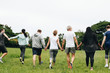 © Rawpixel.com - Group of adults holding hands in the park