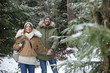 © New Africa - Couple in conifer forest on snowy day, space for text. Winter vacation