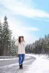 Poster - Young woman walking near snowy forest. Winter vacation