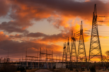 Wall Mural - high-voltage power lines at sunset. electricity distribution station