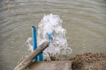 Blue pipe pump rush water falling in pond