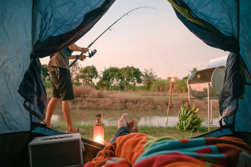 Wall Mural - View from inside of tent with relaxing and fishing in swamp