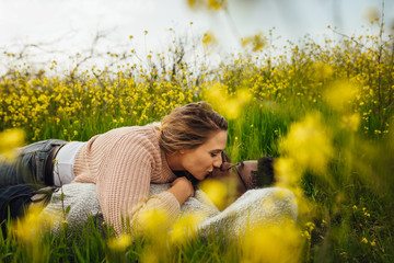 Wall Mural - romantic couple kissing on flowering meadow