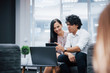 © standret - Haves a break time. Selfie of two smiling office workers in official clothes that sitting near silver laptop on table