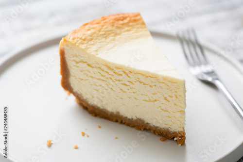 Fotografering  New York Cheesecake Slice On Plate