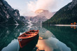 © standret - Autumn time. Wooden boat on the crystal lake with majestic mountain behind. Reflection in the water