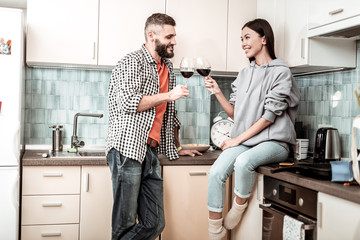 Wall Mural - Bearded handsome man drinking wine with his appealing girlfriend