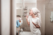 Delighted positive woman singing in the bathroom
