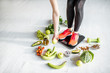 © rh2010 - Sports woman weighing on the scales with healthy food around. Weight loss, healthy food and sports lifestyle concept