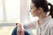 © StockPhotoPro - Girl relaxing next to a window