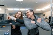 © Valerii Honcharuk - Young couple talking looking at the clock, healthy lifestyle, gym background