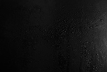 Drops Of Water On A Dark Glass Texture Background