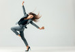 © master1305 - Happy business woman dancing and smiling in motion isolated over white studio background. Human emotions concept. The businesswoman, office, success, professional, , happiness, expression concepts