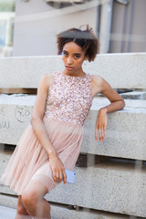 Canvas Print - Street fashion. Portrait of an African young woman in pink dress