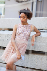 Canvas Print - Street fashion. Portrait of an African young woman in pink dress