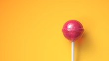 Sweet Lollipop On Bright Yellow Background With Copy Space