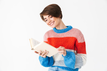 Sticker - Happy cheerful girl wearing sweater sitting on a chair