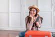 © weedezign - Young asian woman traveler packing stuff in orange suitcase prepare for holiday vacation at home.backpacker travel concept.