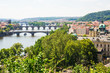 Scenic view of bridges on the Vltava river and of the historical center of Prague: buildings and landmarks of old town with red rooftops