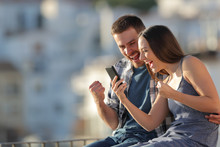 Excited Couple Celebrating Online Phone News Outdoors