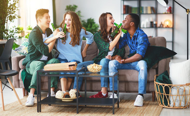 Canvas Print - group of happy friends with beer and pizza at home