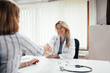 © bnenin - Smling female doctor handshake with a patient.