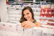 © bnenin - Cheerful woman buying at pharmacy store.