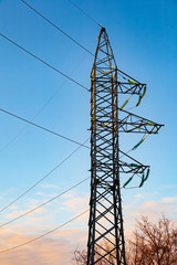 Wall Mural - High voltage electricity pylon and transmission power line on the blue sky and white clouds on the background. Parts of electrical equipment and high voltage power line insulators.