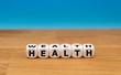 © Fokussiert - Dice form the words 'wealth' and 'health'