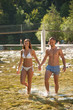 © Samo Trebizan - Active young couple chilling out in river  on a hot summer day standing and walking in water