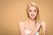 © LIGHTFIELD STUDIOS - Joyful young woman touching long straight hair