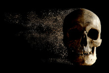 The Human Skull Is Falling Apart In The Wind Like Sand . Concept: Nothing Is Timeless. Isolated On Black. Memento Mori.