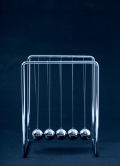 Newtons Cradle balancing balls, business concept in studio