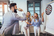© Mediteraneo - Business people making team training exercise during team building seminar, play darts