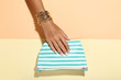 © 5second - Female hand with bracelets and handbag on colorful background