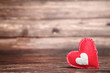 Red fabric heart on brown wooden table