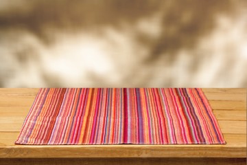 Poster - Wooden table and colorful napkin on background