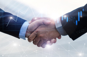 business man handshake on office building background with graph chart of stock market and network connection graphic diagram, partnership business, teamwork global, technology and digital concept