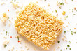 dry instant noodles with seasonings on a white background close-up