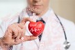 © BillionPhotos.com - Young man doctor holding red heart