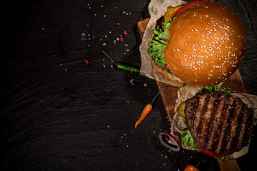 Top view of tasty burgers on wooden table.