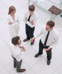 top view.a group of business people talking standing in the office