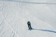 Man skiing downhill on a slope. Skier on a slope. Winter sport concept. Top angle view on skier.
