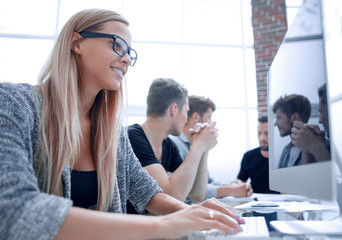 Wall Mural - the girl is smiling and looking at the monitor