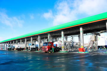 Large green industrial gas station for refueling vehicles, trucks and tanks with fuel, gasoline and diesel in the winter