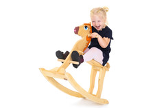Girl Swinging On A Wooden Horse.
