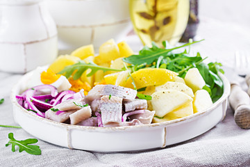 Traditional  salad of salted herring fillet, eggs, fresh apples,  red onion  and potatoes. Kosher food. Scandinavian cuisine.