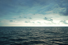 Cloudy Evening Sky Over The Sea Surface Of The Water